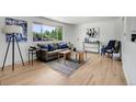 Bright living room with a large window and hardwood floors at 433 S Vaughn Way, Aurora, CO 80012