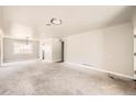 Open concept living room with large windows and neutral decor at 1230 Peoria St, Aurora, CO 80011