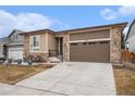 Beautiful single-Gathering home with stone accents, two-car garage, and a well-maintained lawn at 5331 Routt Ct, Arvada, CO 80002