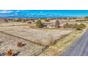 Expansive property featuring a home, barn, paddock, and perimeter ranch fencing with views of mountains and cityscape at 12925 Sierra Cir, Parker, CO 80138