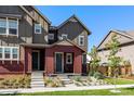 Beautiful exterior of townhome with two tone siding, attractive landscaping, and a welcoming entrance at 6129 Dayton St, Denver, CO 80238