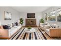 Bright living room featuring a fireplace and stylish furniture at 7452 Otis St, Arvada, CO 80003