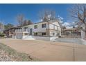 A charming two-story home with a fenced yard and a welcoming entrance with large white steps at 4090 S Tamarac Dr, Denver, CO 80237