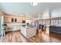 Bright, open kitchen with an island, stainless appliances, and hardwood floors at 4090 S Tamarac Dr, Denver, CO 80237