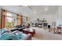 Spacious living room boasts large windows, fireplace, vaulted ceilings and flows with natural light at 6503 Big Horn Trl, Littleton, CO 80125