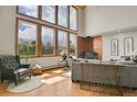 Bright living area with hardwood floors, large windows and a cozy sitting area at 27100 Molly Dr, Conifer, CO 80433