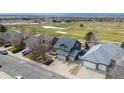 Aerial view showcasing a landscaped house in a golf course neighborhood at 319 Mountain View Ave, Fort Lupton, CO 80621