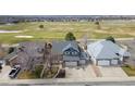 Suburban home with a lawn, driveway and a beautiful golf course view at 319 Mountain View Ave, Fort Lupton, CO 80621