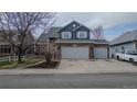 Charming home featuring a two-car garage, brick facade, and manicured front yard landscaping at 319 Mountain View Ave, Fort Lupton, CO 80621