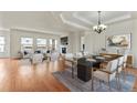 Open dining room with hardwood floors and modern chandelier at 14240 Ivanhoe St, Thornton, CO 80602