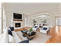 Spacious living room with hardwood floors and a fireplace at 14240 Ivanhoe St, Thornton, CO 80602