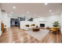 Bright and spacious living room featuring hardwood floors, fireplace, and neutral décor at 3318 S Dayton Ct, Denver, CO 80231