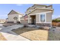 Charming home with a welcoming front porch, complemented by a well-kept lawn and inviting curb appeal at 12202 Village Cir, Brighton, CO 80603