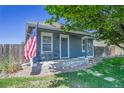 A charming single-story home with a welcoming front porch and decorative rock landscaping at 2791 Quarterland St, Strasburg, CO 80136