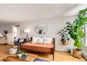 Open living space featuring hardwood floors, plants, modern furnishings and a large mirror at 1390 N Emerson St # 407, Denver, CO 80218