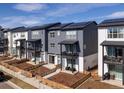 View of modern townhouses featuring balconies, solar panels, and landscaped front yards at 2721 W 167Th Pl, Broomfield, CO 80023