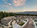 Scenic aerial view of the community with tree coverage and mountain views in the distance at 16113 Enchanted Peak Way, Monument, CO 80132