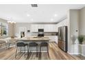 Modern kitchen with a granite island, stainless steel appliances, and a dining area adjacent at 4500 Copeland Cir # 104, Highlands Ranch, CO 80126