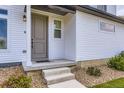 Close-up of the home's entrance, featuring a welcoming front porch and tasteful landscaping at 10136 Worchester St, Commerce City, CO 80022