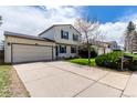 Inviting two-story home with a spacious driveway, lush lawn, and a well-manicured garden at 10720 Moore Cir, Westminster, CO 80021
