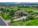 Beautiful exterior featuring a well-kept lawn, mature trees, and an attached garage at 5424 Hacienda Pl, Parker, CO 80134