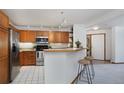 Efficient kitchen with stainless steel appliances, breakfast bar, and modern lighting at 315 Arapahoe Ave # 202, Boulder, CO 80302