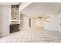 Spacious living room with tile flooring and a stone fireplace at 931 S Zeno Way # 107, Aurora, CO 80017