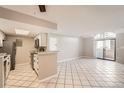 Bright open-concept living room and kitchen area with light-colored walls at 931 S Zeno Way # 107, Aurora, CO 80017