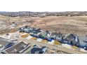 Stunning aerial view of a neighborhood with well-manicured lawns in a rolling landscape at 5695 Cadara Way, Parker, CO 80134