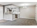 Open floor plan with living room and kitchen featuring modern gray cabinets at 18004 E Ohio Ave # 101, Aurora, CO 80017