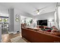 Bright living room featuring hardwood floors, a ceiling fan, and a comfortable seating area, perfect for relaxation at 3116 S Lincoln St, Englewood, CO 80113
