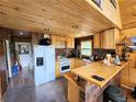 Kitchen with wood countertop and cabinetry, modern appliances, and access to the outdoor space at 573 97 Cir, Breckenridge, CO 80424