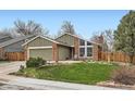 Charming home with a brick exterior, well-kept lawn, large windows, and a cozy front patio at 8101 S San Juan Range Rd, Littleton, CO 80127