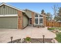 Charming home featuring brick accents, a spacious driveway, and beautifully landscaped front yard at 8101 S San Juan Range Rd, Littleton, CO 80127