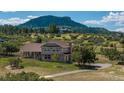 Stunning two-story home with lush landscaping, complemented by a scenic mountain view and a private driveway at 3488 Dawson Rd, Sedalia, CO 80135