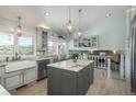 This kitchen features a farmhouse sink, stone countertops, and a kitchen island with seating at 3488 Dawson Rd, Sedalia, CO 80135