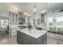 Elegant kitchen featuring custom cabinets, granite countertops, a central island, and a cozy window seat at 3488 Dawson Rd, Sedalia, CO 80135