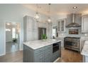 Open kitchen featuring an island with granite countertops, stainless appliances, and plenty of storage space at 3488 Dawson Rd, Sedalia, CO 80135
