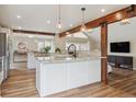 Bright and airy kitchen featuring an island, granite countertops, and stainless steel appliances at 5149 E Links Cir, Centennial, CO 80122