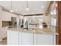 Open-concept kitchen with granite countertops, an island and stainless steel appliances at 5149 E Links Cir, Centennial, CO 80122