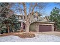 Charming two-story home features a covered porch, stone accents, and a two-car garage at 9882 S Hoyt Ct, Littleton, CO 80127