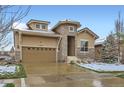 Attractive home with a stone entryway, large windows, and a spacious two-car garage at 15855 Wild Horse Dr, Broomfield, CO 80023