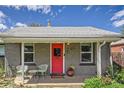 Inviting front porch with red door, potted plants and chairs, providing a welcoming entrance at 1629 Valentia St, Denver, CO 80220
