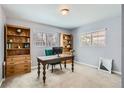 Cozy home office with natural light, built-in bookshelves, and a comfortable workspace at 1629 Valentia St, Denver, CO 80220