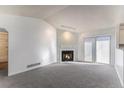 Bright living room boasts a fireplace and sliding door access to the outdoors at 17968 E Colgate Pl, Aurora, CO 80013