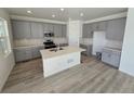 Well-lit kitchen features gray cabinets, white countertops, and a central island at 8816 Whiteclover St, Littleton, CO 80125