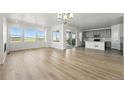 Bright, open-concept living space featuring hardwood floors, large windows, and a modern kitchen at 8816 Whiteclover St, Littleton, CO 80125
