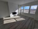 Bright living room boasts a fireplace, large windows, and scenic views at 8816 Whiteclover St, Littleton, CO 80125