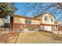 Two-story brick house with attached garage and landscaping at 14657 E Oregon Dr, Aurora, CO 80012