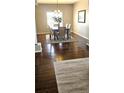 Inviting dining room with elegant hardwood floors, stylish rug, and modern decor at 21580 Longs Peak Ln, Parker, CO 80138